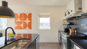 a kitchen with a sink and a counter top at The Carter by AvantStay in Nashville +242 photos