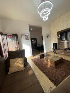 a living room with a couch and a coffee table at Modern 1 Bedroom Apartment with Balcony in Enugu
