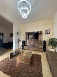 a living room with a couch and a coffee table at Modern 1 Bedroom Apartment with Balcony in Enugu