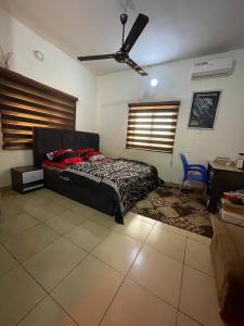 a bedroom with a bed and a ceiling fan at Modern 1 Bedroom Apartment with Balcony in Enugu