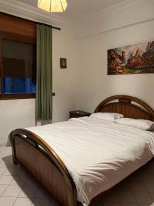 a bedroom with a large bed with white sheets at Azure Sky Villa in Casablanca
