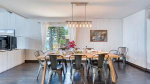 a dining room with a large wooden table and chairs at Lakeview by AvantStay Private Waterfront Cabin on Lake Tahoe w Hot Tub Views in Tahoe Vista