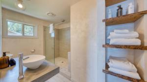 a bathroom with a sink and a shower and towels at Lakeview by AvantStay Private Waterfront Cabin on Lake Tahoe w Hot Tub Views in Tahoe Vista +43 photos