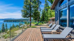 a deck with chairs and a view of the water at Lakeview by AvantStay Private Waterfront Cabin on Lake Tahoe w Hot Tub Views in Tahoe Vista
