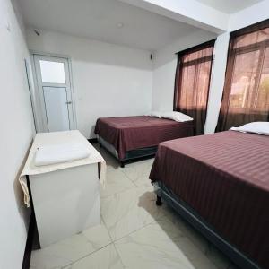 Postel nebo postele na pokoji v ubytování Hotel Julián Cotuc