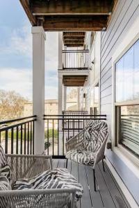 a balcony with two chairs and a window at Queen City Getaway with Pool in Charlotte