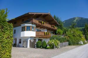 a house with a balcony on the side of it at Appartement Margaretha in Westendorf