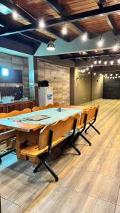 a large wooden table and chairs in a room at Alojamiento Napoleon in Puerto Iguazú +8 photos