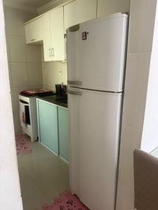 a kitchen with a white refrigerator and a stove at Gilvan Rocha in Aracaju