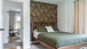 a bedroom with a bed with a floral wallpaper at Charcoal Chalet by AvantStay A Design w Firepit in New Paltz
