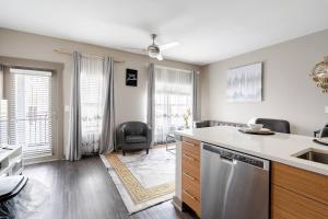 a kitchen with a sink and a dishwasher at Queen City Getaway with Pool in Charlotte