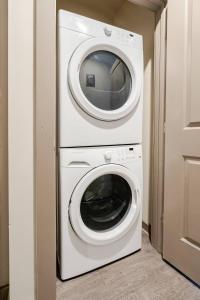 a washing machine and a dryer in a room at Queen City Getaway with Pool in Charlotte