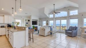 Sleeps 28 Beachfront w Pool Hot Tub Game Room Atlantic Watch by AvantStay في كيل ديفيل هيلز: مطبخ وغرفة معيشة مطلة على المحيط