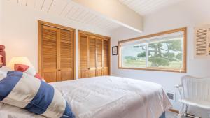 a bedroom with a large bed and a window at West Beach Wonderland by AvantStay Waterfront in Oak Harbor