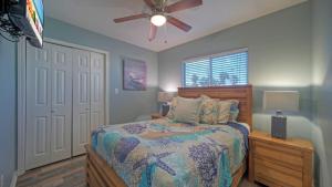 a bedroom with a bed and a ceiling fan at Stylish 2BR Coastal Getaway w Pool Prime Location Lazy Fun in Port Aransas +34 photos