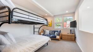 a bedroom with a bunk bed and a couch at Chic Whidbey Island Waterfront Home w Hot Tub Firepits Views in Coupeville +41 photos