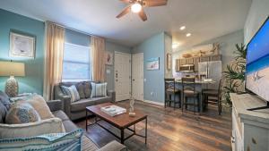 a living room with a couch and a table at Stylish 2BR Coastal Getaway w Pool Prime Location Lazy Fun in Port Aransas