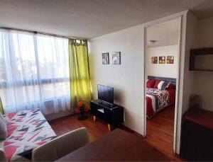 a room with a bedroom with a bed and a mirror at Metroapart 1 in Santiago