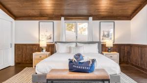 a bedroom with a large bed and two windows at Explorer by AvantStay Close to Slopes Game Room Guest Suite Hot Tub in Alpine Meadows