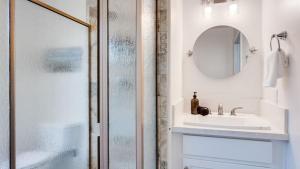 a bathroom with a shower and a sink and a mirror at Beachfront 2BR w Deck Views Direct Sand Access Strand Way A in Oceano +28 photos