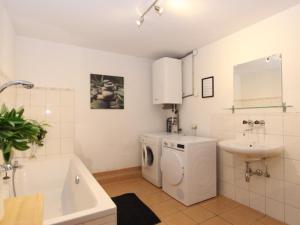 a bathroom with a washing machine and a sink at Mooshausl in Gnesau +53 photos