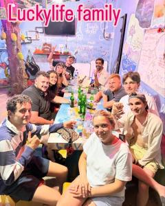 a group of people sitting around a table at Family Hostel in Lovina