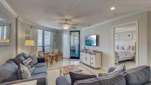a living room with a couch and a bed at 308 Summerhouse by AvantStay Oceanview Condo w Community Pool Access in Isle of Palms