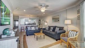 a living room with a couch and a table at 308 Summerhouse by AvantStay Oceanview Condo w Community Pool Access in Isle of Palms