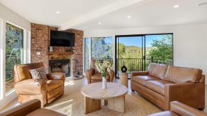 Designer Retreat w Pool Firepits Panoramic Views The Lake House at Malibu في أغورا هيلز: غرفة معيشة مع أثاث من الجلد ومدفأة