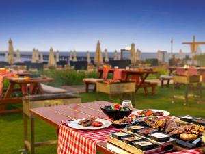 a picnic table with plates of food on top of it at Rixos Premium Seagate in Sharm El Sheikh