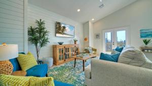 a living room with a blue couch and a table at Free Heated Pool Golf Cart Zone Sea La Vie by AvantStay in Port Aransas