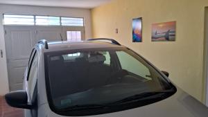 a car parked in a garage next to a garage door at Casa Julia in Puerto Madryn