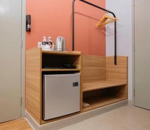 a kitchen with a small refrigerator in a room at Singgah Pengerang Hotel in Pengerang