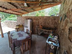 a kitchen with a table and a sink in a room at Hostal Ayllu con cochera in Urubamba
