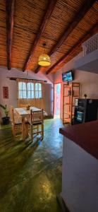 a living room with a table and chairs in it at Tierra Norte - Cabañas in Tilcara