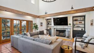 a living room with a couch and a fireplace at Wellsona Vineyard Retreat Pool Hot Tub Views Main Home Guest Home in Paso Robles
