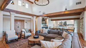 a living room with a couch and a table at Wellsona Vineyard Retreat Pool Hot Tub Views Main Home Guest Home in Paso Robles