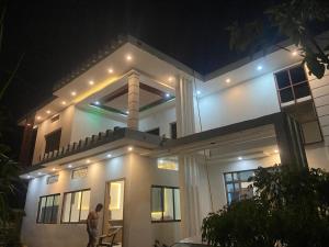 a man standing in front of a house at night at Hotel Aurihar jn in Saidpur