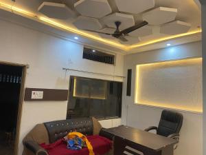 a room with a couch and a table and a ceiling at Hotel Aurihar jn in Saidpur