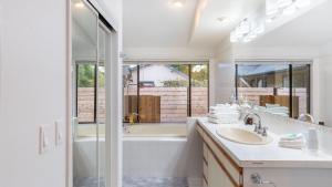 a bathroom with a tub and a sink and a shower at Oceanfront w Game Room Fire Pit Panoramic Views Angels Landing by AvantStay in Langley +42 photos