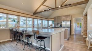 a kitchen with a large island with bar stools at Sonoma Sunshine by AvantStay Countryside Views in Glen Ellen