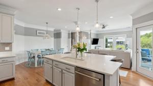 a kitchen and living room with a table and chairs at 3800 Cameron Boulevard AvantStay Pool Ocean Views Deck in Isle of Palms