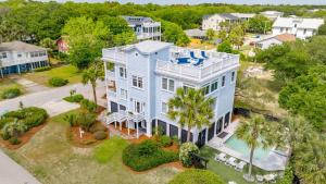 an aerial view of a large blue house with a pool at 3800 Cameron Boulevard AvantStay Pool Ocean Views Deck in Isle of Palms