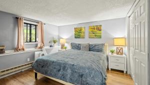 a bedroom with a bed and two windows at Timberline Retreat by AvantStay Forest Views Minutes to Camelback Resort in Tannersville