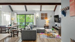a living room with a couch and a table at Timberline Retreat by AvantStay Forest Views Minutes to Camelback Resort in Tannersville