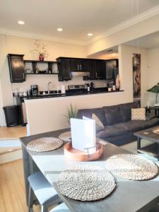 a kitchen and living room with a table with plates on it at Cornerstone West Lower Unit in Savannah