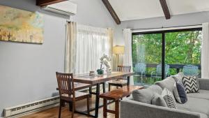 a living room with a table and a couch at Timberline Retreat by AvantStay Forest Views Minutes to Camelback Resort in Tannersville