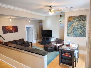 a living room with a couch and a table at Cornerstone West Lower Unit in Savannah