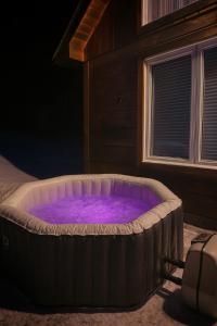 a large hot tub in a room with a window at #90 Lakefront 3-bdrm Chalet in Muskoka in Port Carling