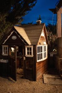 a small dog house with a door and windows at Tierra Mia Hacienda Ruta del Vino in Valle de Guadalupe